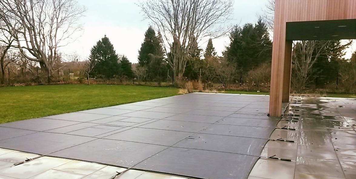 LOOP-LOC Aqua-Xtreme Virtually Solid Mesh safety pool cover installed over a pool